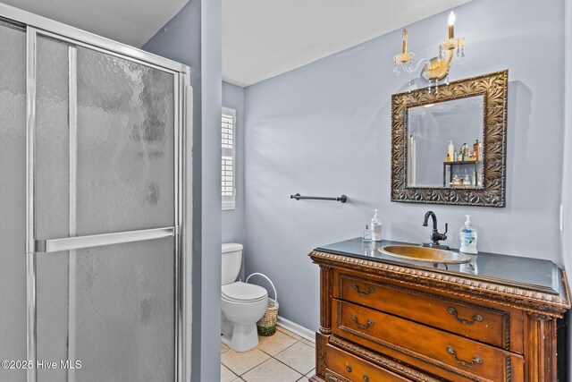 1613 E Pelican Dr, Oak Island, NC 28465 - full bathroom with a shower stall, toilet, vanity, and tile patterned floors