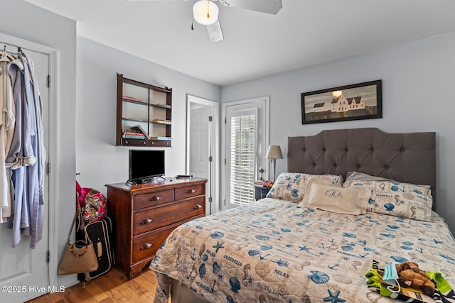 1613 E Pelican Dr, Oak Island, NC 28465 - bedroom with light wood-style floors and a ceiling fan