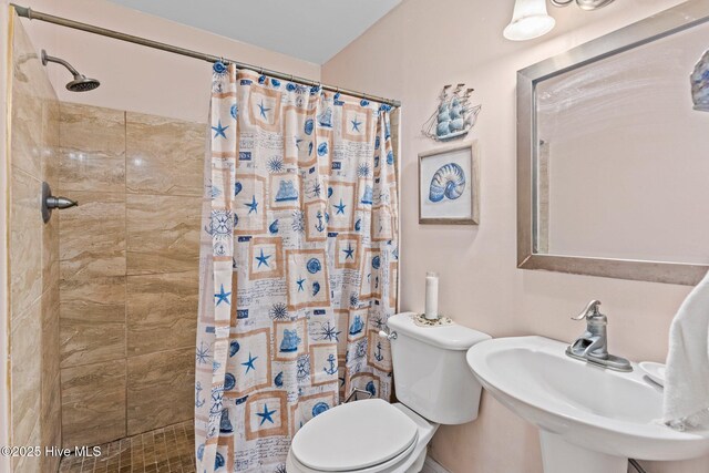 1613 E Pelican Dr, Oak Island, NC 28465 - full bath with toilet, tiled shower, and a sink
