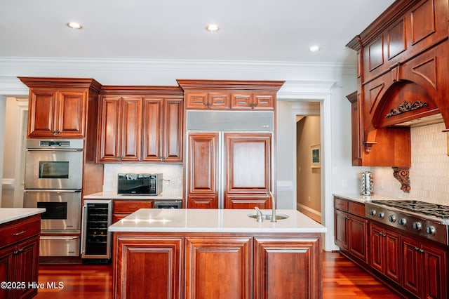 kitchen with appliances with stainless steel finishes, a sink, light countertops, beverage cooler, and a warming drawer