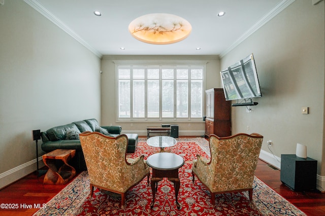 sitting room featuring baseboards, ornamental molding, and wood finished floors
