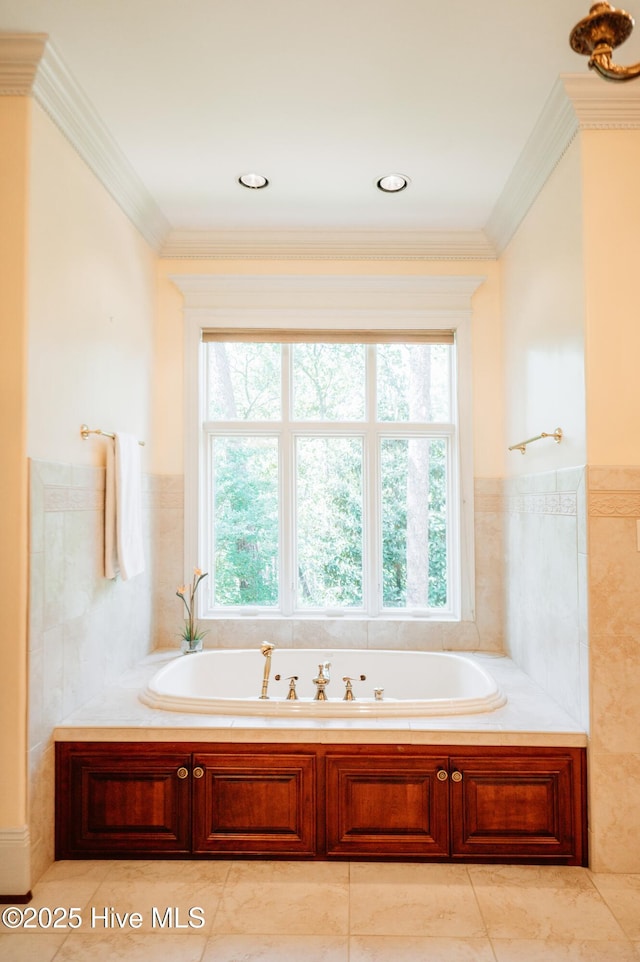 full bath with a wainscoted wall, plenty of natural light, and a bath