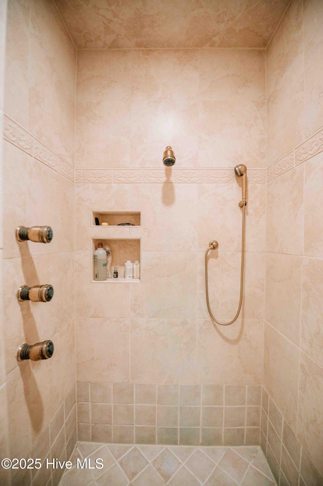 bathroom with a tile shower