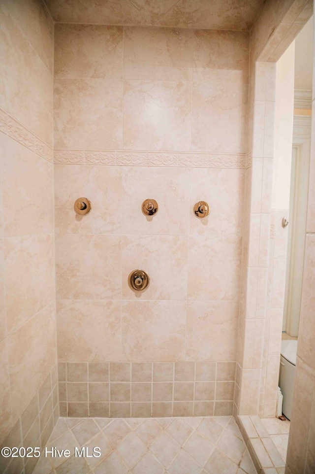 bathroom with tiled shower