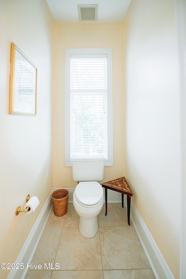 bathroom with visible vents, baseboards, and toilet