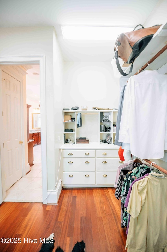 walk in closet featuring light wood finished floors
