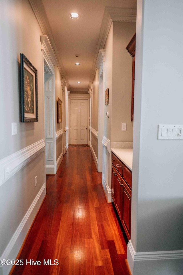 hall with ornamental molding, recessed lighting, and dark wood-type flooring