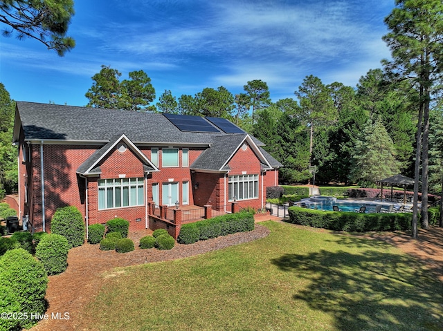 16 Mulbren Ct, Pinehurst, NC 28374 - view of front of home featuring a gazebo, brick siding, roof mounted solar panels, and a front yard