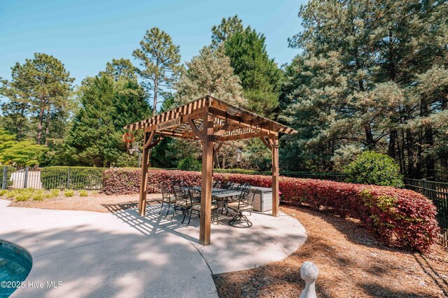view of patio featuring a pergola, fence, and outdoor dining area