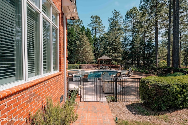 view of pool featuring fence, a patio, and a pool with connected hot tub