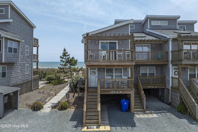 1774 New River Inlet Rd Unit 5, North Topsail Beach, NC 28460 - exterior space with stairs, a water view, a balcony, and a pergola