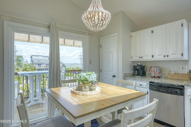 1774 New River Inlet Rd Unit 5, North Topsail Beach, NC 28460 - dining space with lofted ceiling and a notable chandelier