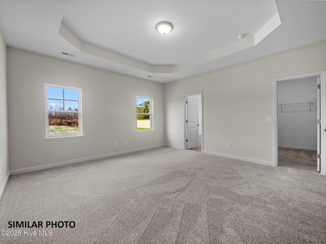 139 Tides End Dr, Holly Ridge, NC 28445 - unfurnished bedroom with a tray ceiling, carpet, and baseboards