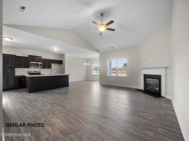 139 Tides End Dr, Holly Ridge, NC 28445 - unfurnished living room featuring a sink, wood finished floors, ceiling fan with notable chandelier, a fireplace with flush hearth, and visible vents