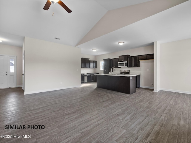 139 Tides End Dr, Holly Ridge, NC 28445 - kitchen with open floor plan, stainless steel appliances, light countertops, a sink, and high vaulted ceiling