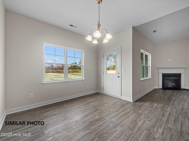 139 Tides End Dr, Holly Ridge, NC 28445 - interior space featuring a healthy amount of sunlight, a chandelier, and wood finished floors