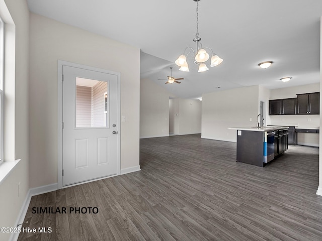 139 Tides End Dr, Holly Ridge, NC 28445 - kitchen featuring dark wood-style floors, light countertops, pendant lighting, open floor plan, and ceiling fan with notable chandelier