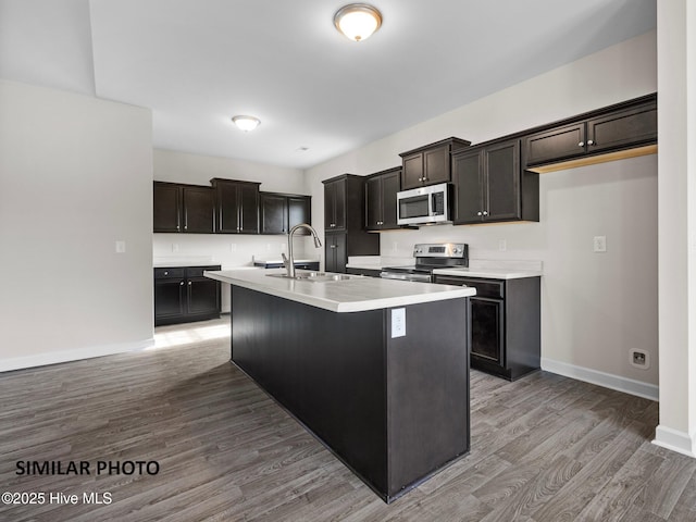 139 Tides End Dr, Holly Ridge, NC 28445 - kitchen featuring a sink, light wood-style floors, baseboards, a kitchen island with sink, and appliances with stainless steel finishes