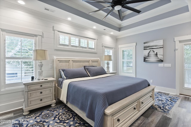 bedroom featuring visible vents, crown molding, a raised ceiling, recessed lighting, and dark wood-type flooring