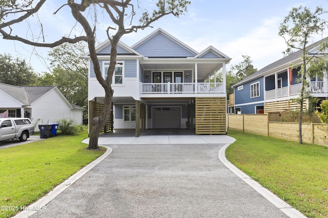 view of front of house featuring stairway, a garage, a front yard, and aphalt driveway