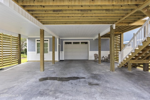 view of patio / terrace with stairway, a carport, and a garage