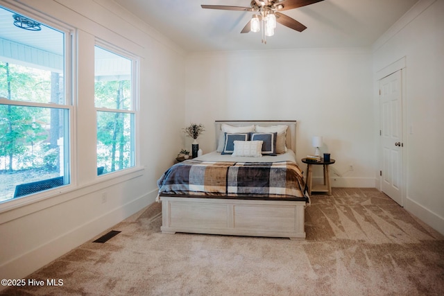 bedroom with visible vents, ornamental molding, carpet, and baseboards