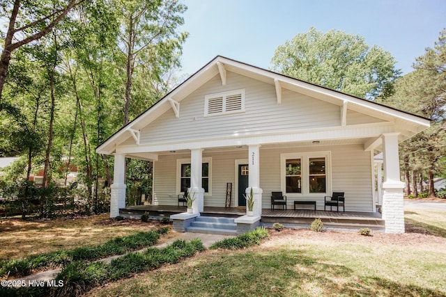 bungalow-style house with covered porch and a front yard