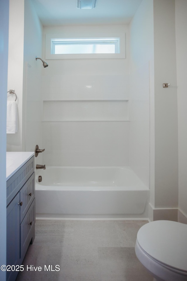 full bathroom featuring shower / washtub combination, vanity, toilet, and a wealth of natural light