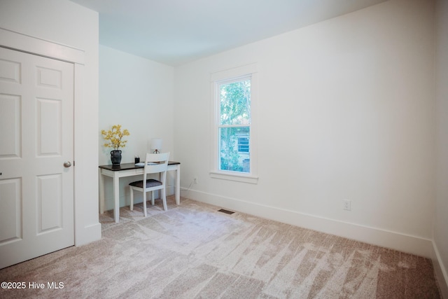 office featuring carpet floors, baseboards, and visible vents