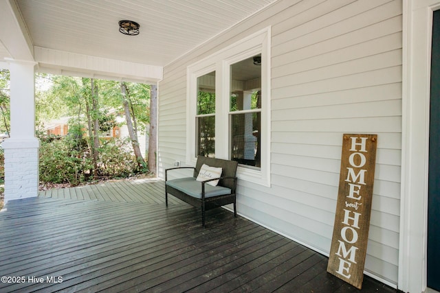 wooden terrace featuring covered porch