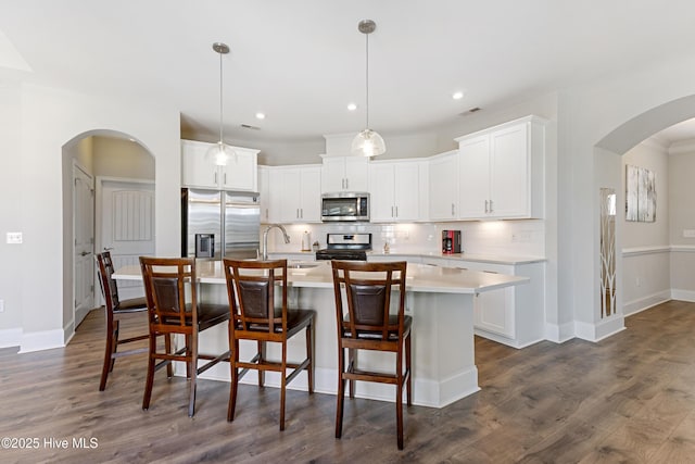 2226 Jasper Forest Trl, Winnabow, NC 28479 - kitchen featuring stainless steel appliances, arched walkways, light countertops, tasteful backsplash, and recessed lighting