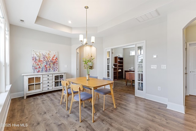 2226 Jasper Forest Trl, Winnabow, NC 28479 - dining space with arched walkways, wood finished floors, a tray ceiling, baseboards, and recessed lighting