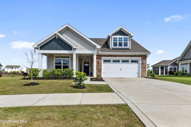 2226 Jasper Forest Trl, Winnabow, NC 28479 - craftsman-style home with a front yard, stone siding, concrete driveway, and a garage