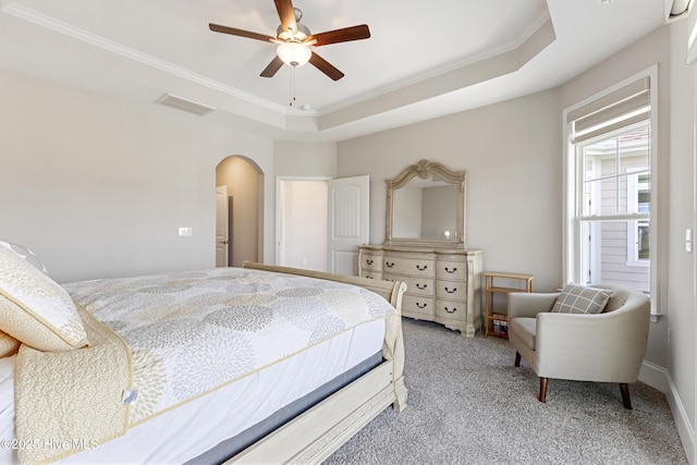 2226 Jasper Forest Trl, Winnabow, NC 28479 - bedroom with arched walkways, light colored carpet, crown molding, a raised ceiling, and a ceiling fan