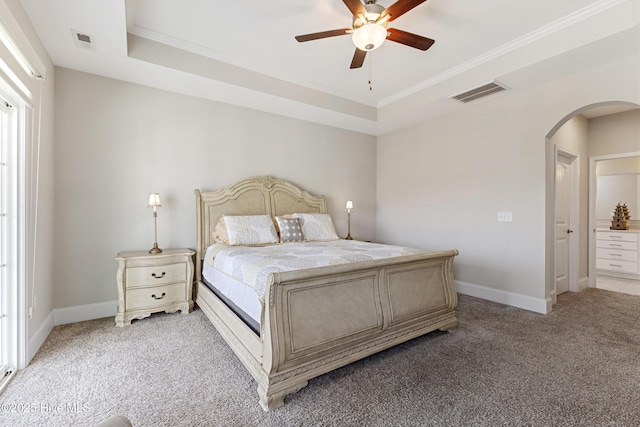 2226 Jasper Forest Trl, Winnabow, NC 28479 - bedroom featuring arched walkways, light carpet, a tray ceiling, baseboards, and ornamental molding