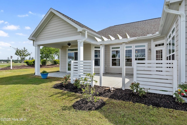 2226 Jasper Forest Trl, Winnabow, NC 28479 - view of side of property featuring a yard, covered porch, roof with shingles, and a ceiling fan