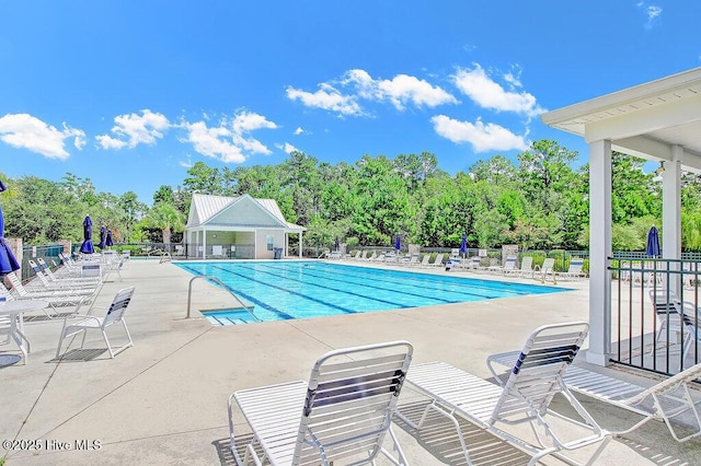 pool featuring a patio and fence