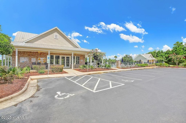 view of building exterior featuring fence and uncovered parking