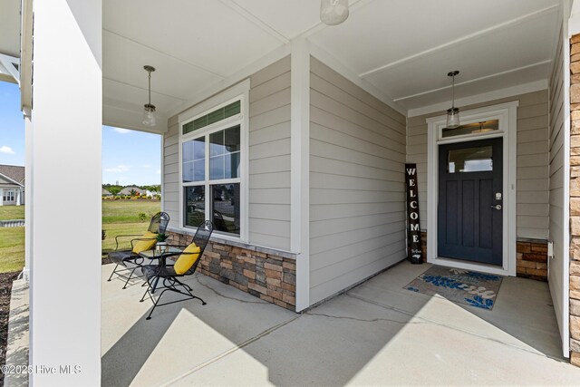 2226 Jasper Forest Trl, Winnabow, NC 28479 - doorway to property featuring a porch and stone siding