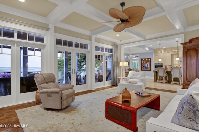 living area with a wealth of natural light, french doors, and coffered ceiling