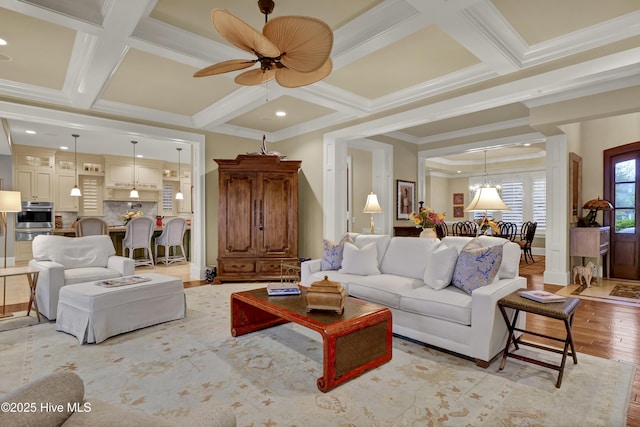 living room with ornamental molding, decorative columns, beamed ceiling, light wood-type flooring, and coffered ceiling