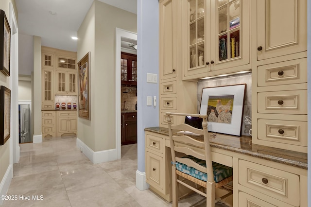 office space with a sink, built in desk, recessed lighting, baseboards, and light tile patterned floors
