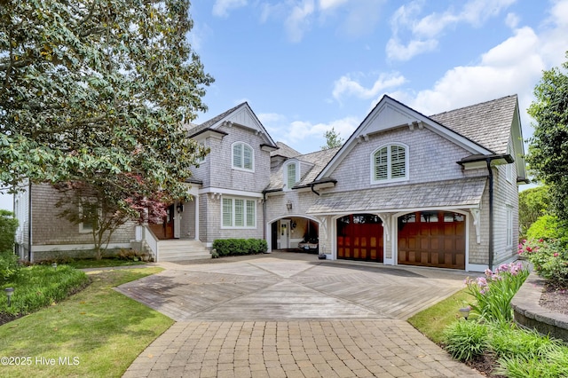 view of front of property with decorative driveway and an attached garage