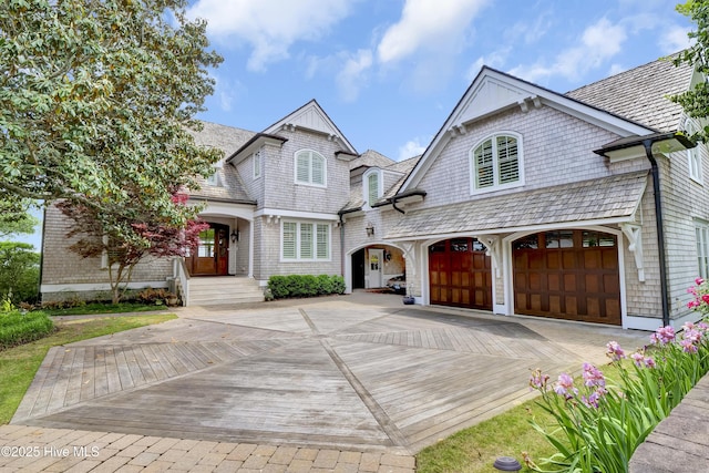 french provincial home featuring a garage and driveway