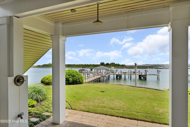 dock area featuring a lawn and a water view