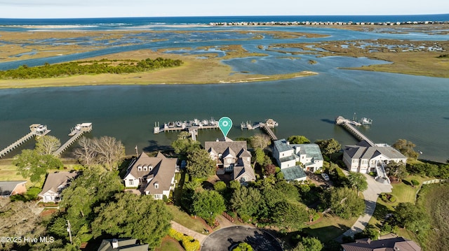 birds eye view of property with a water view and a residential view
