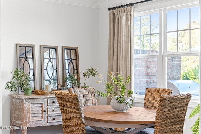 dining space with crown molding