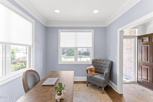 home office featuring baseboards, crown molding, wood finished floors, and a wealth of natural light