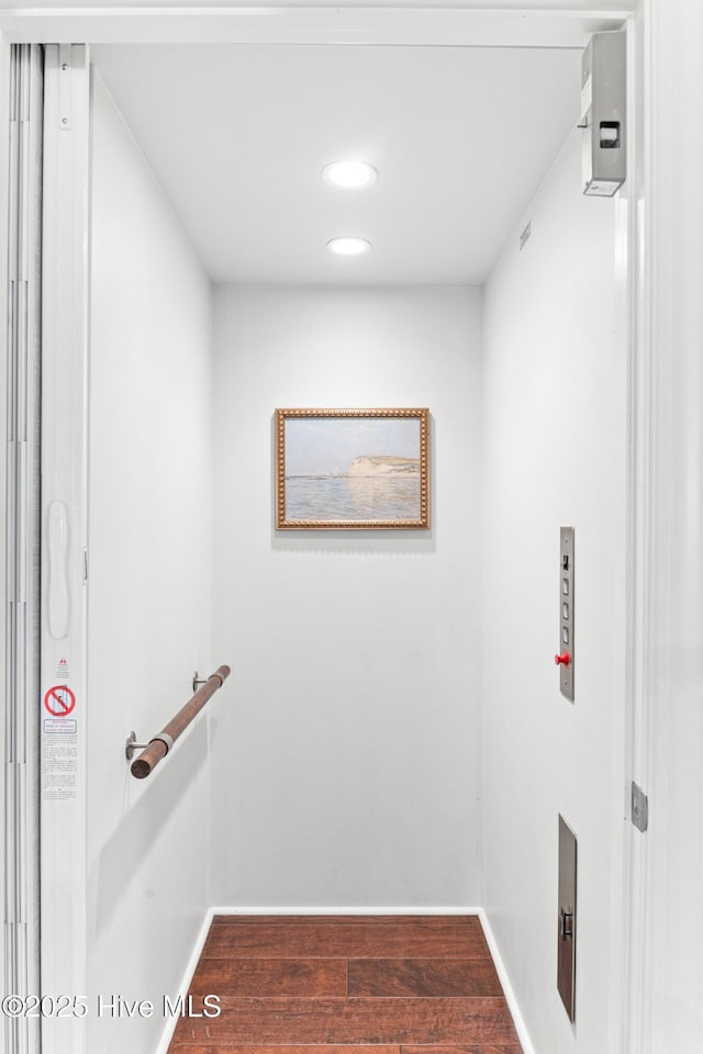 interior space with baseboards, recessed lighting, and wood finished floors