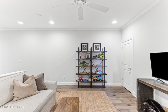 living area with crown molding, recessed lighting, baseboards, and wood finished floors